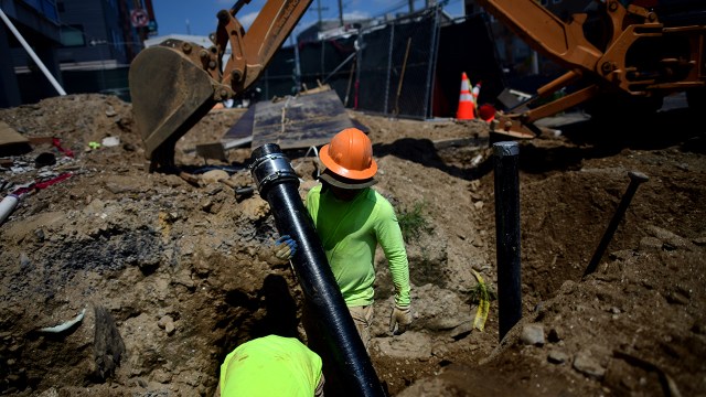 Construction workers dig a sanitation pipe ditch in Philadelphia on Aug. 4, 2022. (Mark Makela/Getty Images)