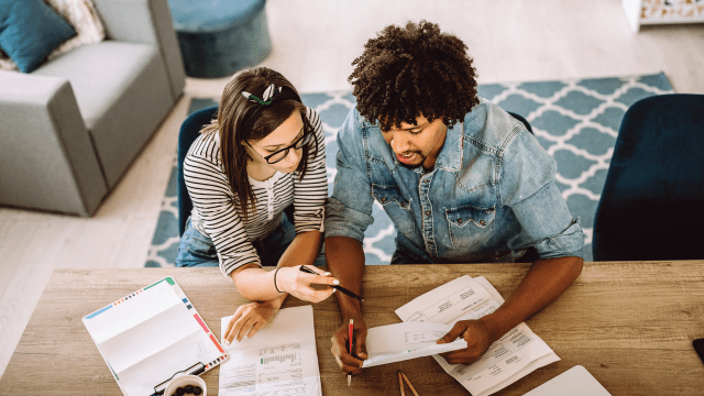 Couple calculating financial bills at home